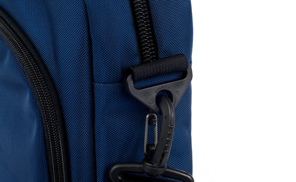 Shoulder strap attachment point at the base of the main compartment zipper.